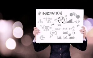 A person holding a poster that says innovation
