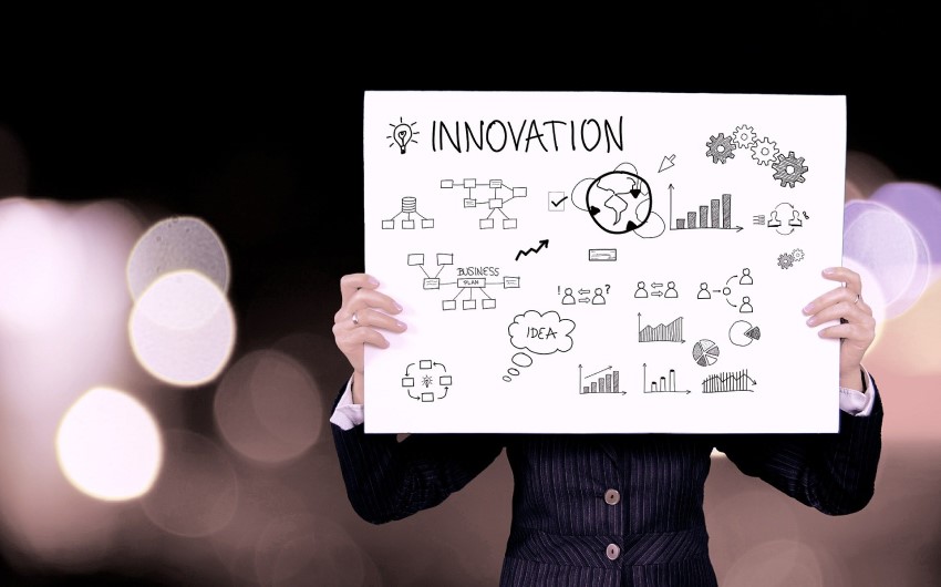 A person holding a poster that says innovation